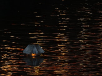 An elegant floating lantern casting soft shadows in a tranquil setting.