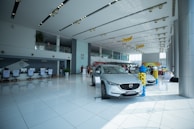 people inside building and different vehicles on display