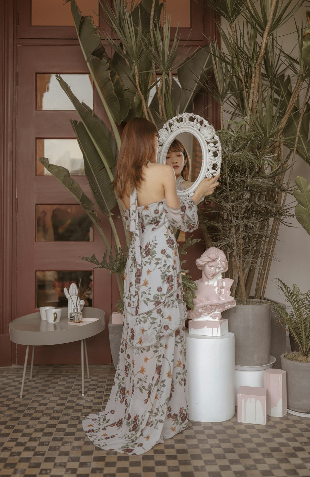 standing woman holding mirror