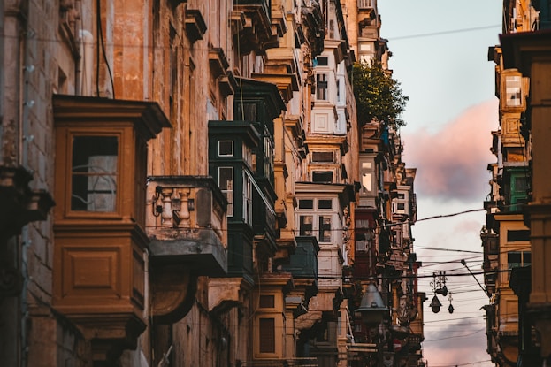 concrete buildings under cloudy sky
