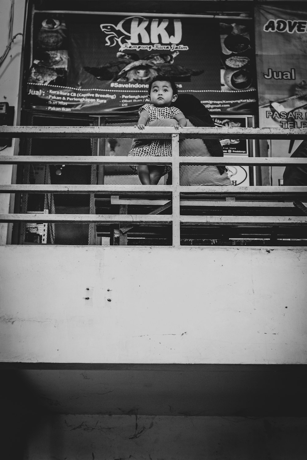 grayscale photo of man holding baby while sitting on sofa