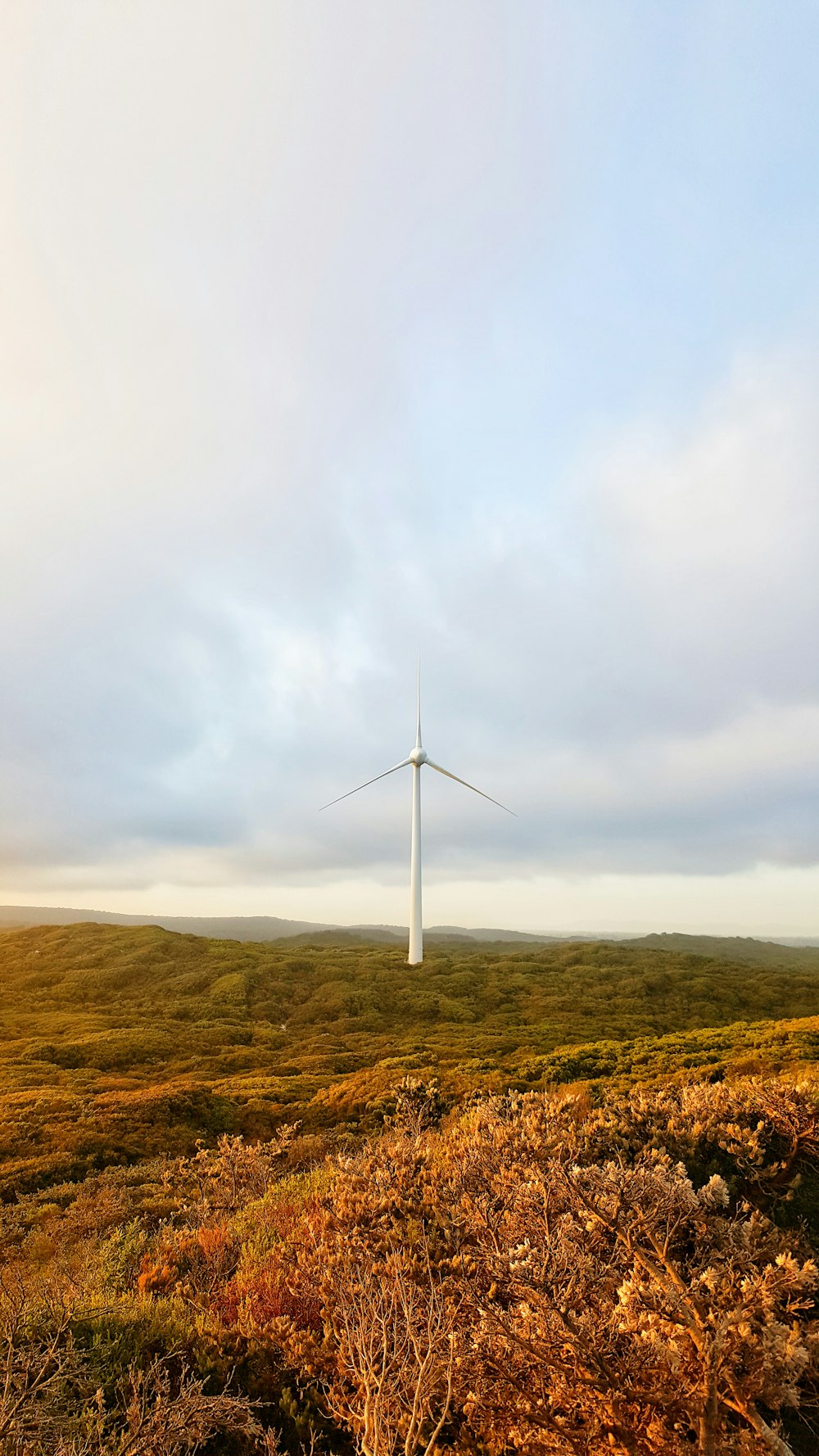 white wind turbine during daytime