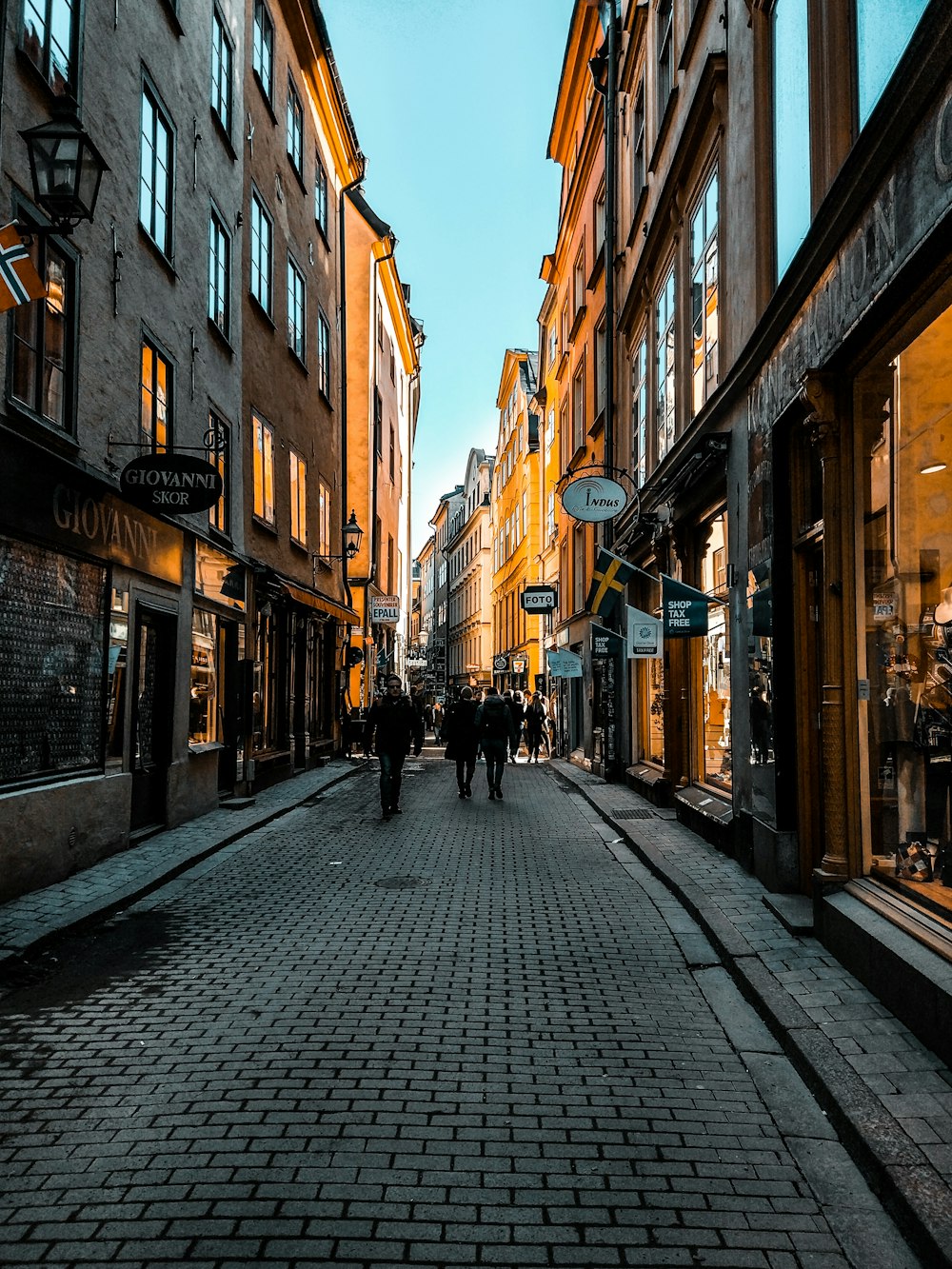 man walking on gray brick road