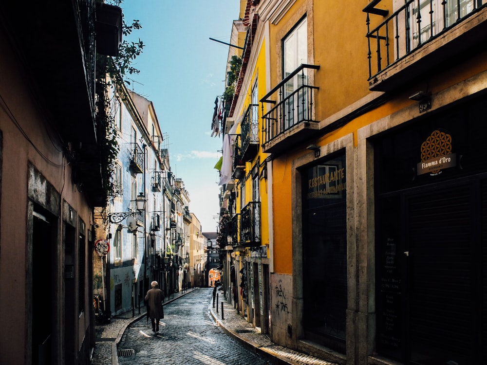 person walking between buildings