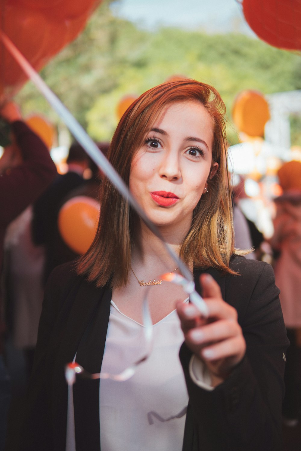 woman holding balloon