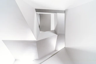 Interior view of a minimalist architectural space featuring clean lines and monochrome colors.