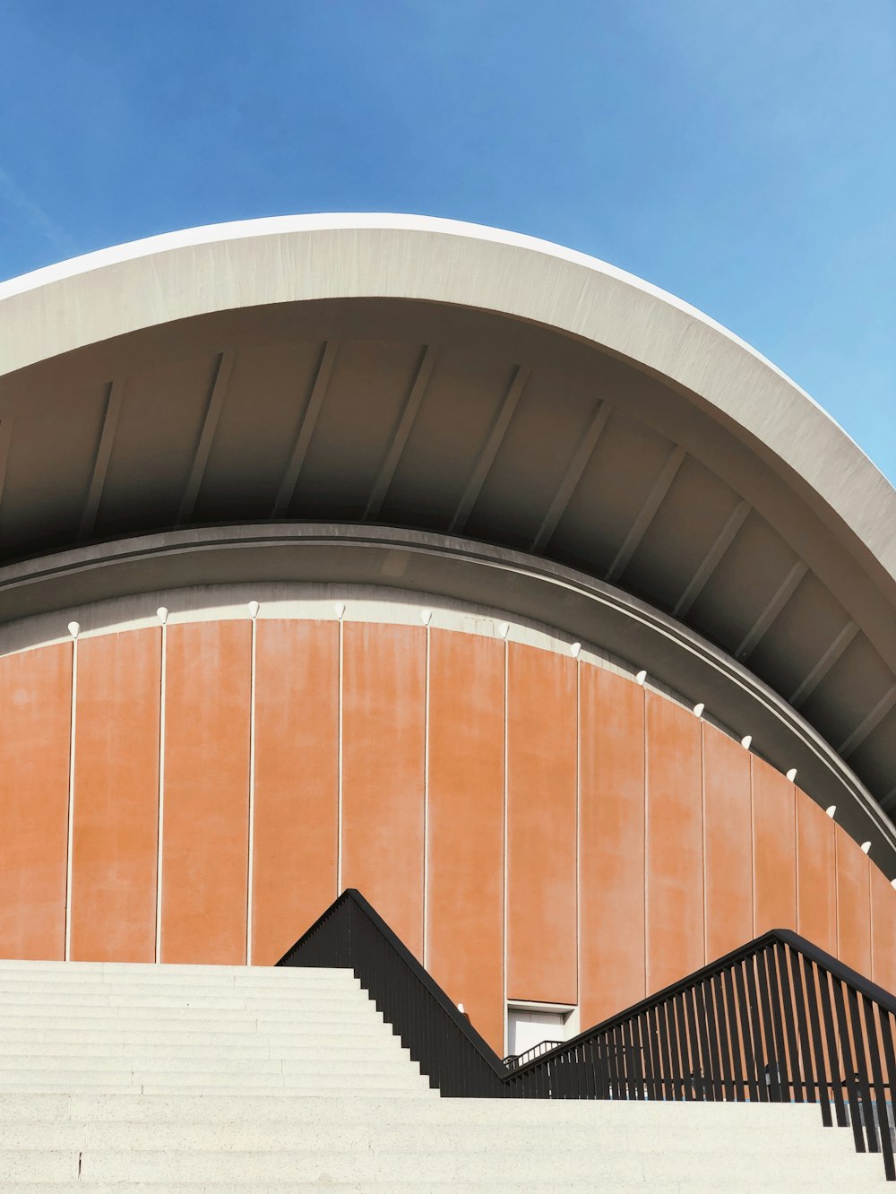 orange and white concrete building under blue sky