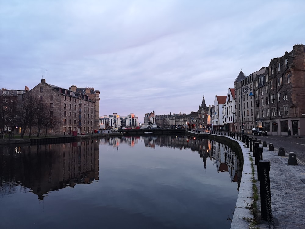 concrete buildings near body of water during daytime