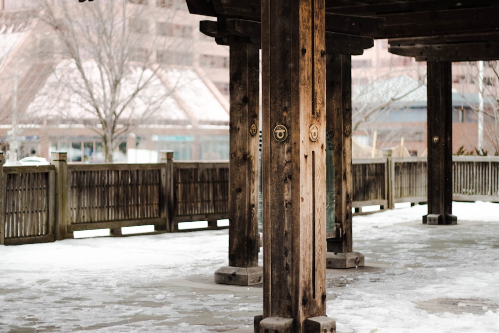 a wooden structure with snow on the ground