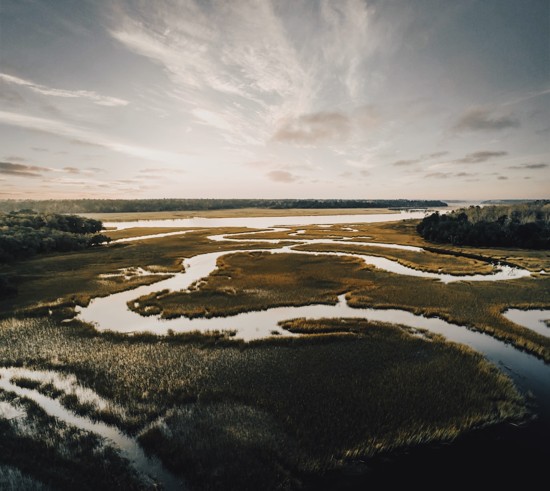 winding river across plains under downcast ssky