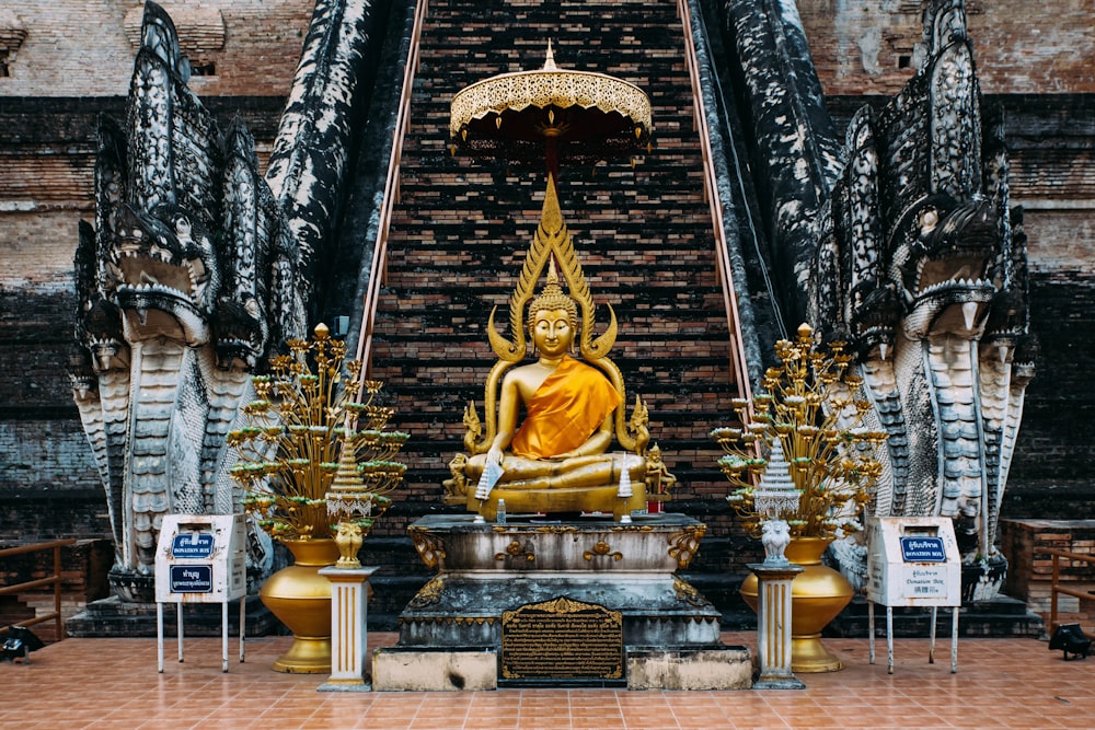 golden buddha by stairs