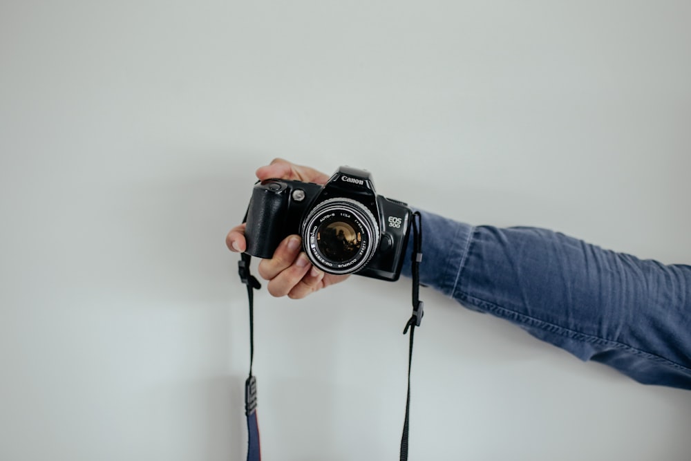 person holding black camera