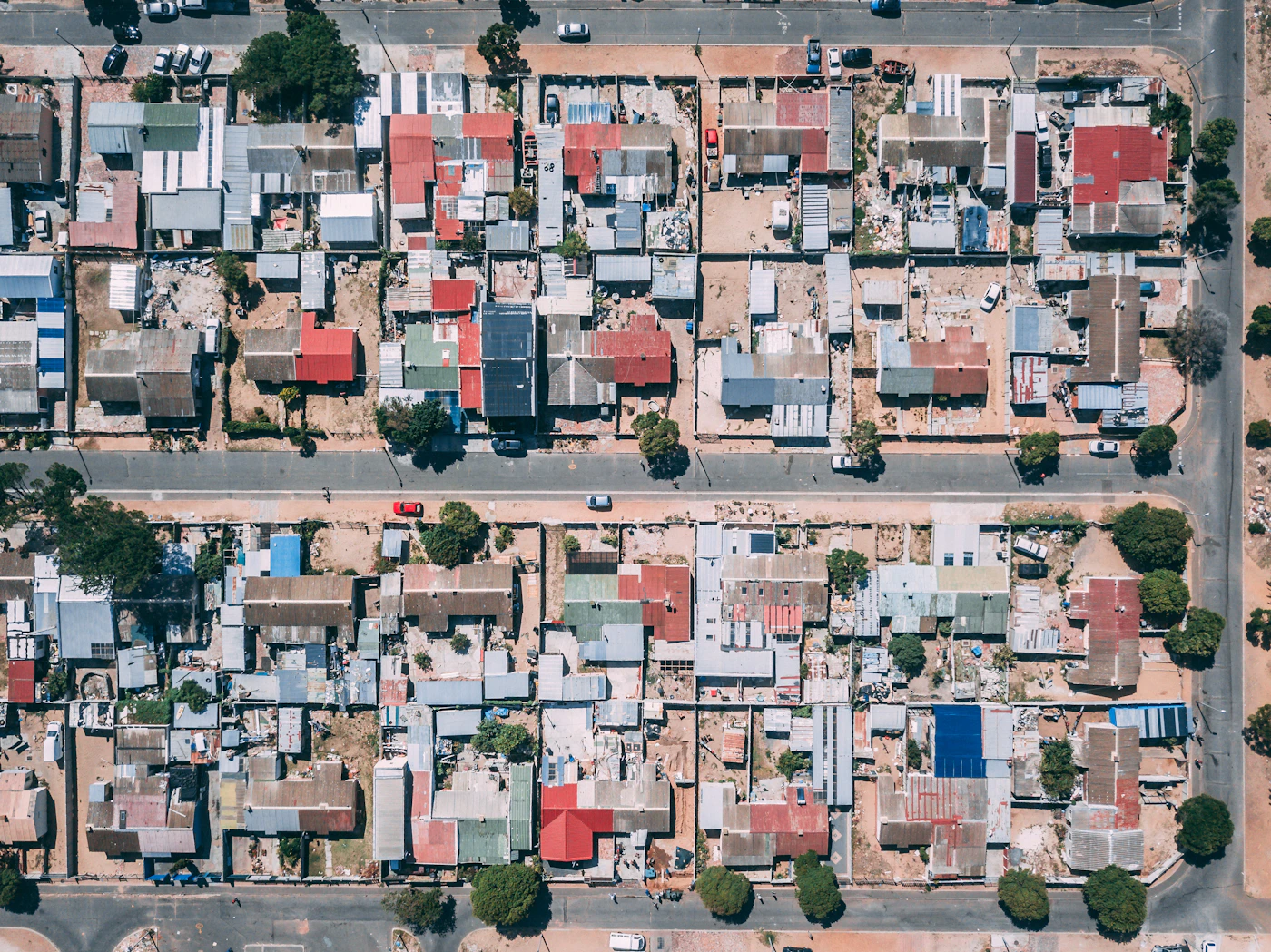 Aerial view of American suburban housing sprawl — the systemic scale of the 5x Trap