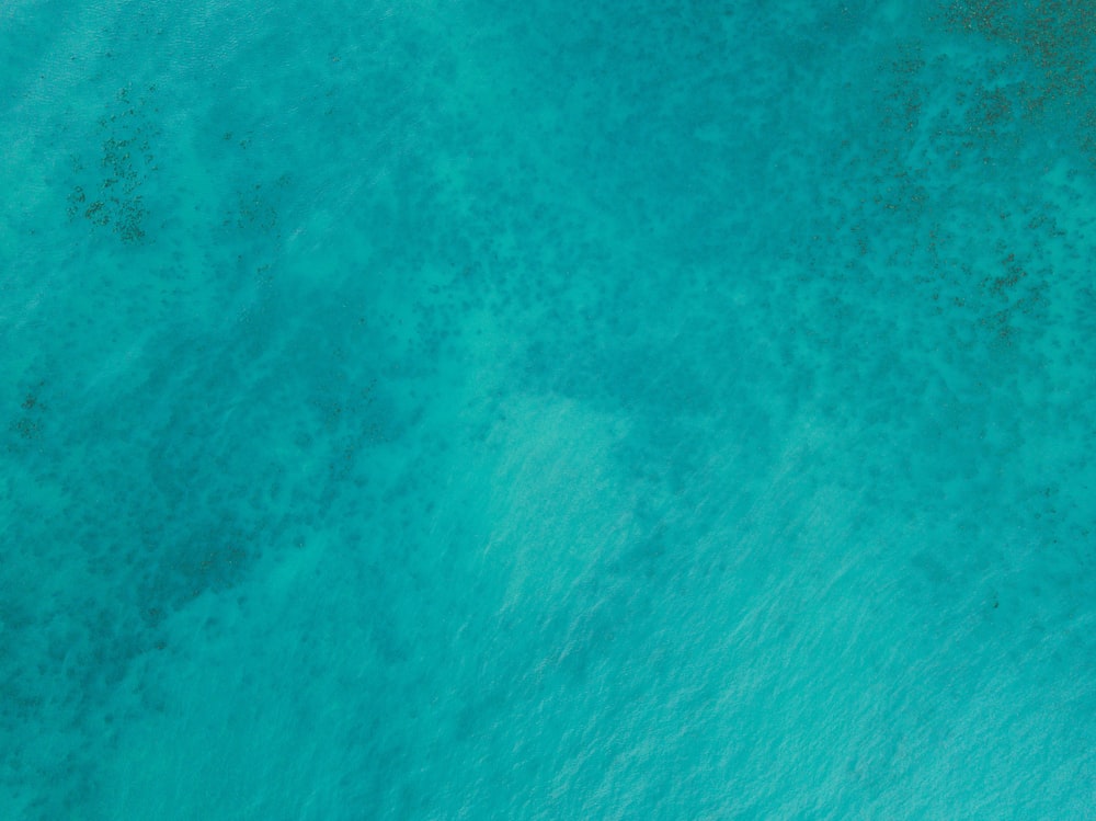 an aerial view of a boat in the ocean