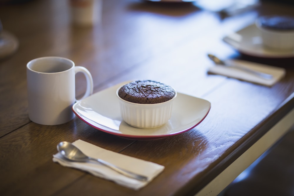 cupcake in ramekin beside mug