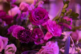 A vibrant arrangement of silk flowers in various shades of purple and pink.