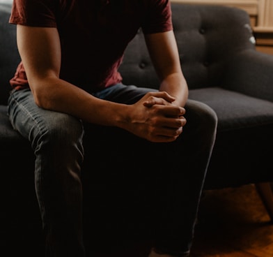 man sitting on sofa