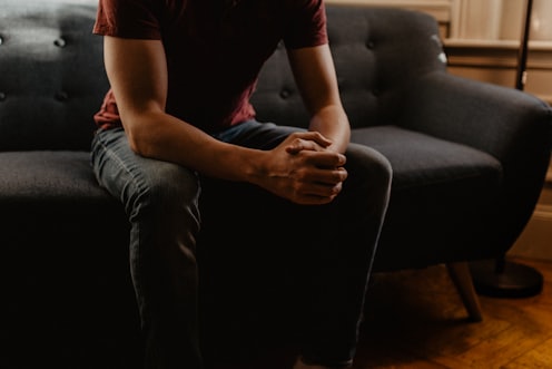 man sitting on sofa