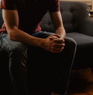 man sitting on sofa