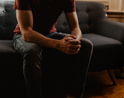 man sitting on sofa