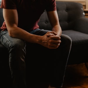 man sitting on sofa