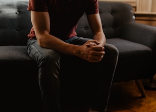 man sitting on sofa