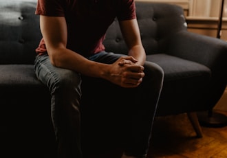 man sitting on sofa