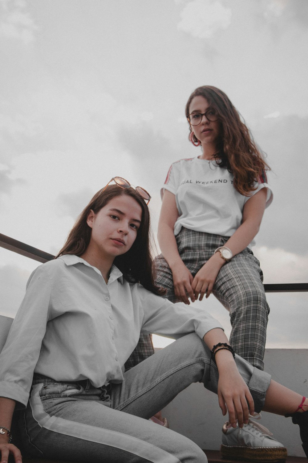 two women sitting on park bench