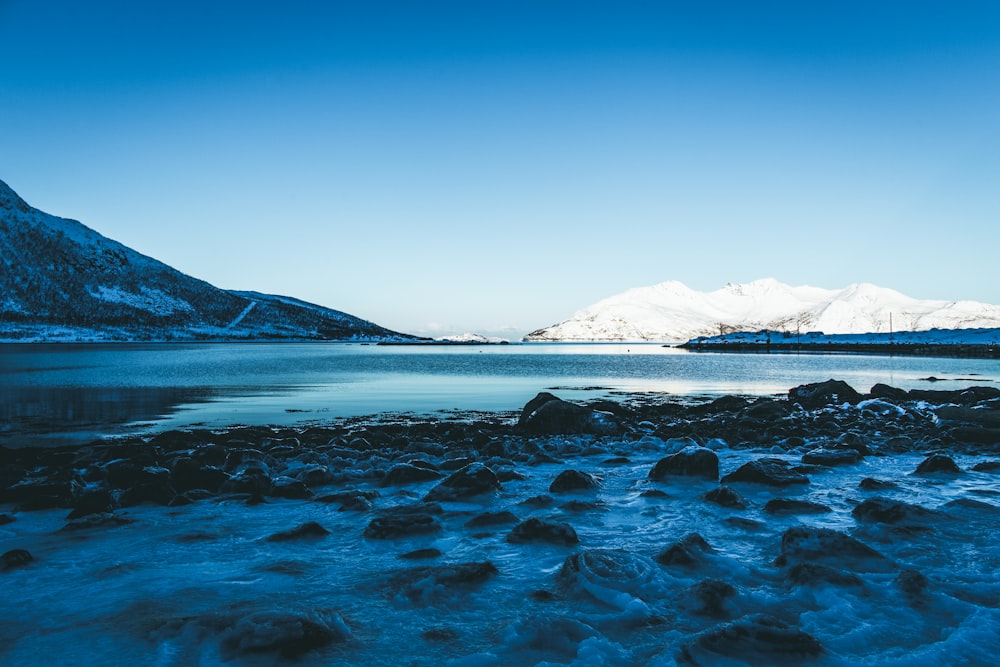 body of water beside mountain