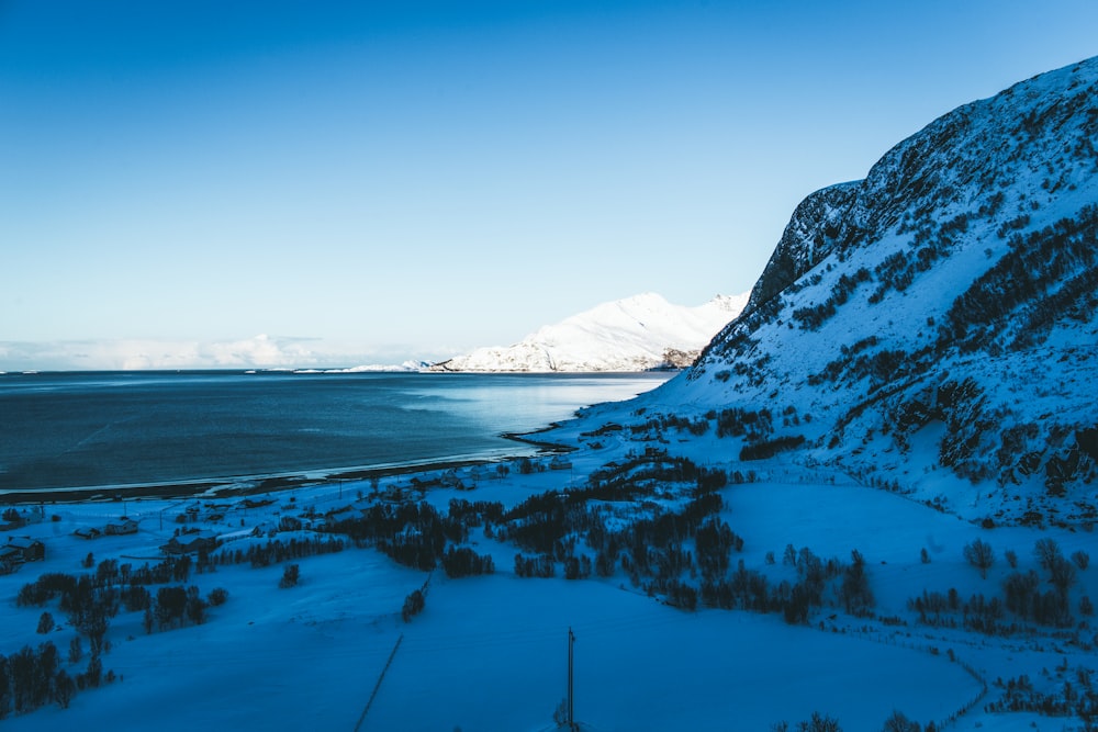 body of water beside mountain