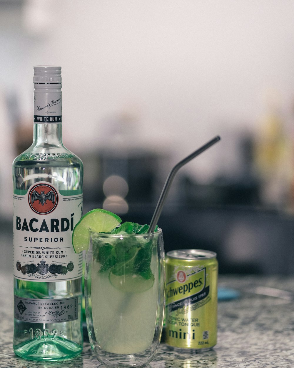 Bacardi superior bottle beside filled drinking glass and beer can