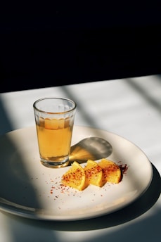 round white ceramic plate with sliced oranges
