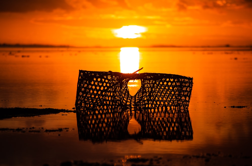 silhouette of fish net seashore