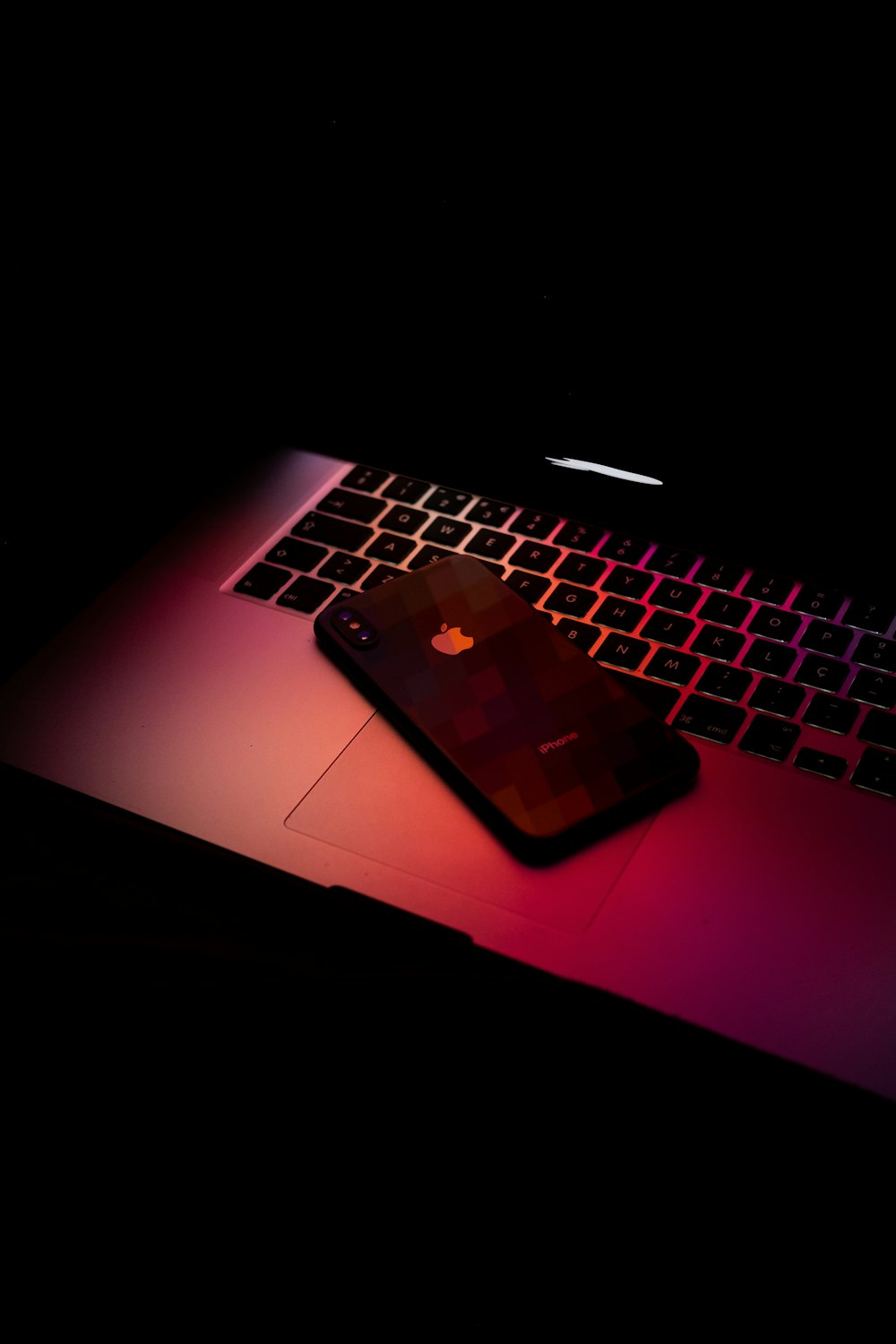 black iPhone X on MacBook Pro