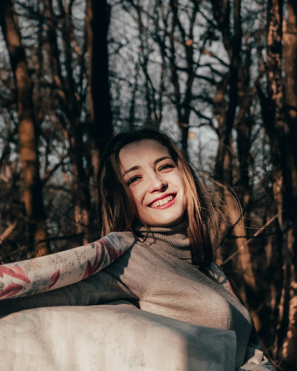 woman smiling while waving her scarf