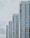 A series of modern high-rise apartment buildings with numerous windows and balconies, positioned side by side in a slightly staggered formation. The buildings appear to be well-maintained and have a uniform architectural style with a clean, minimalistic design.
