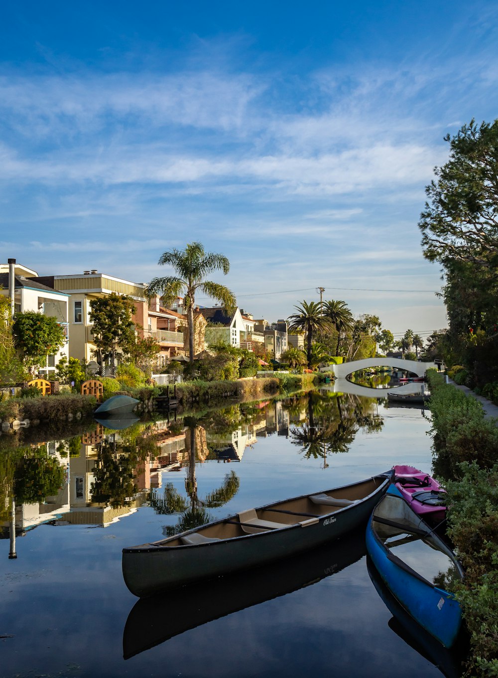 two gray and blue canoes on body of water during daytime