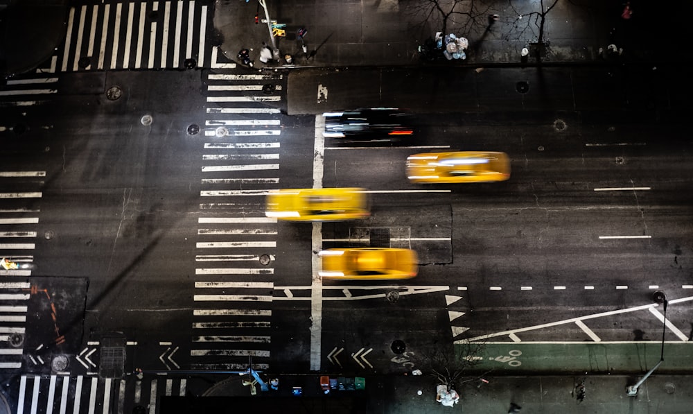 time lapse photo of three yellow vehicles