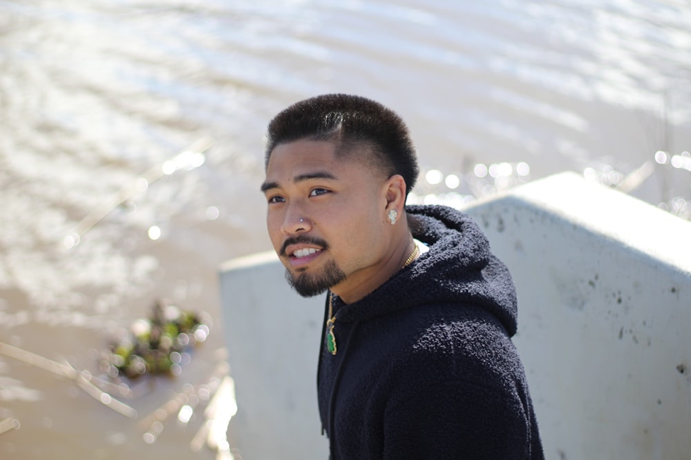 selective focus photography of ma standing near body of water