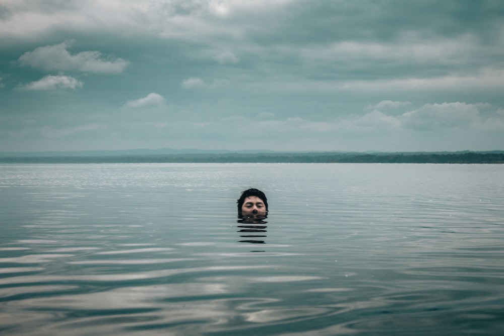 man in the middle of ocean