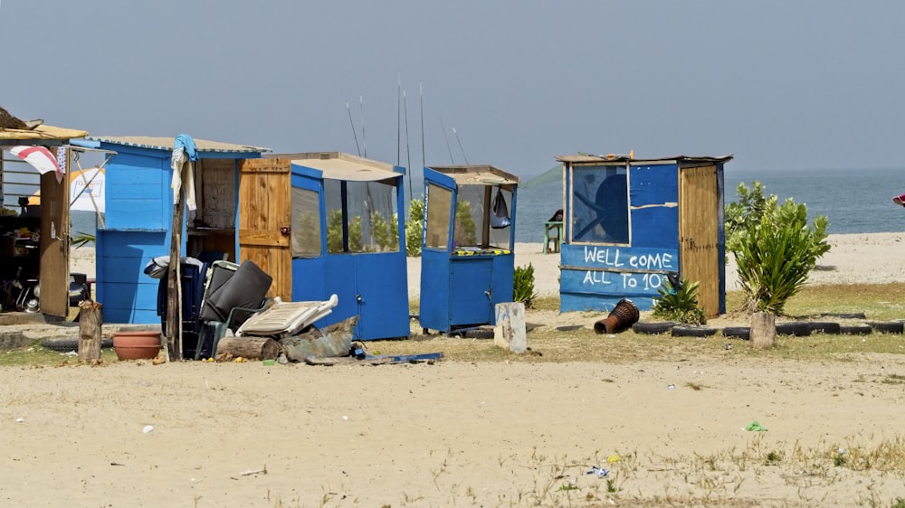 blue and brown wooden stalls near ocean