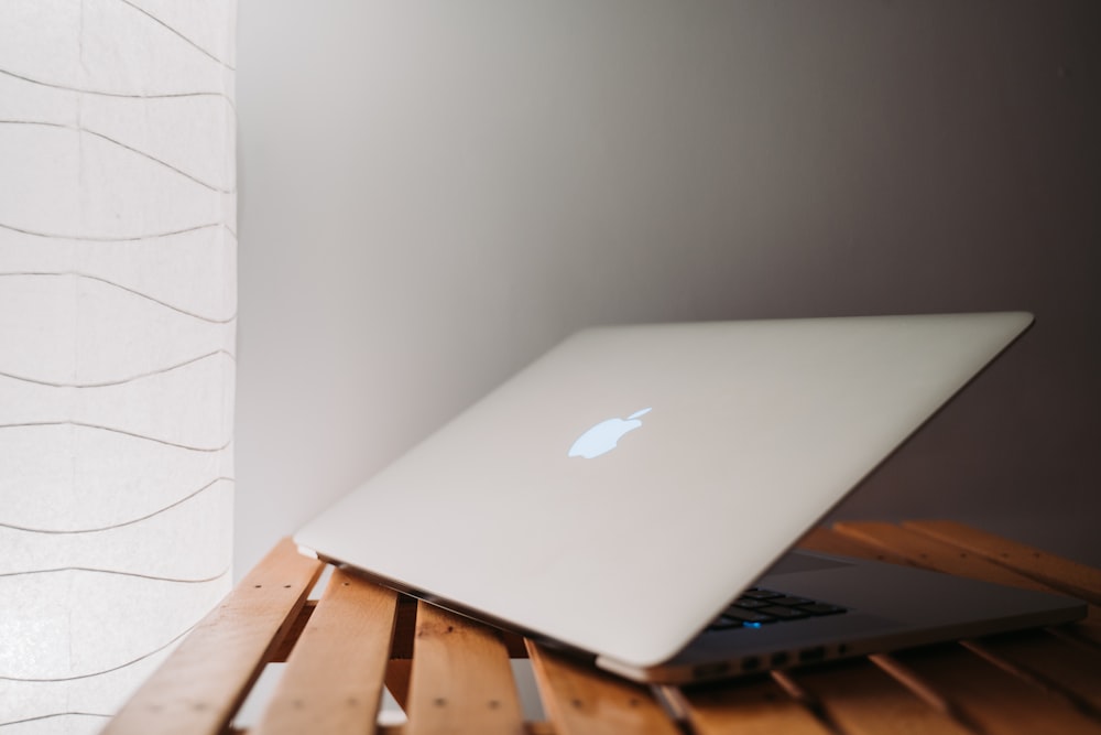 MacBook Pro on brown wooden surface