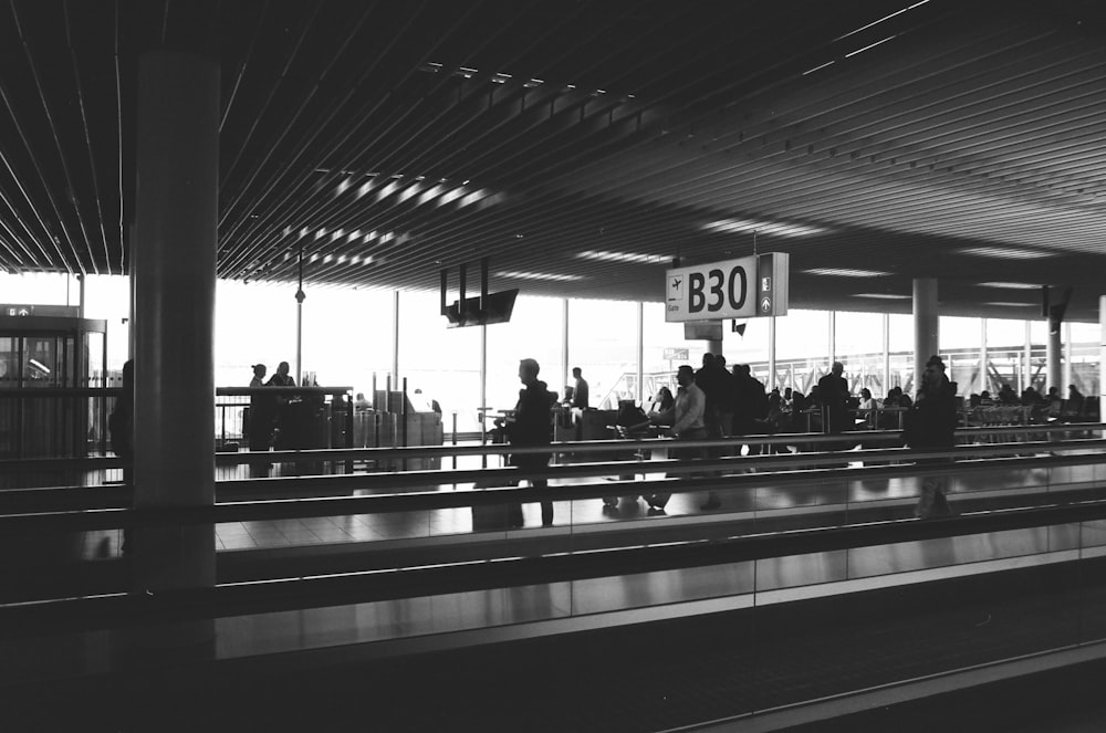 people standing and walking inside building during daytime