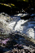 Close-up of flowing clean water with sunlight sparkling on the surface.