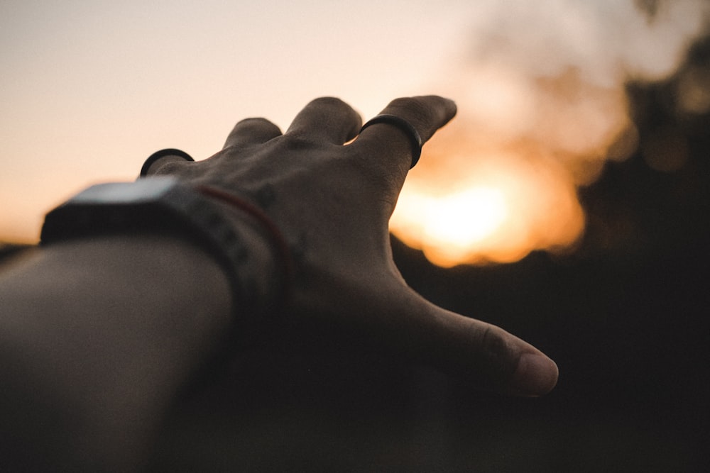 left person's hand pointing yellow light