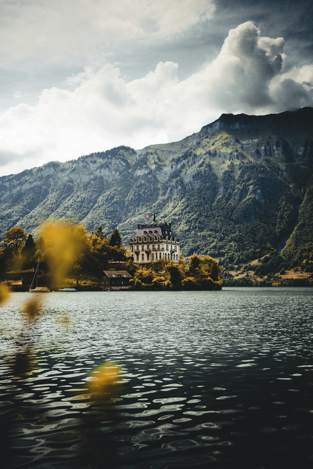 white house near body of water under white clouds