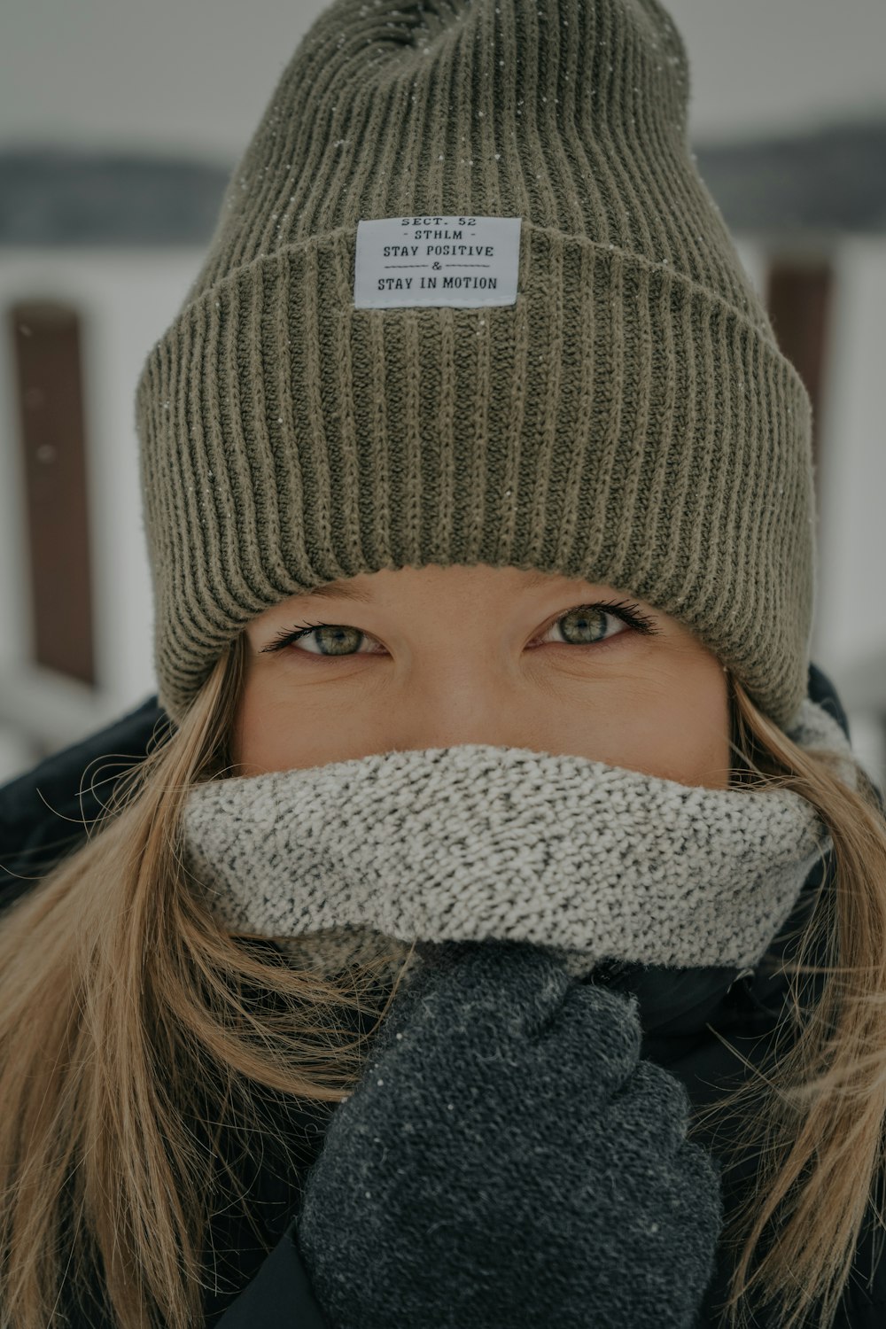 woman covering her face with coat