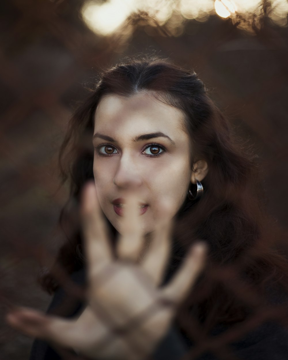 selective focus photography of woman behind fence