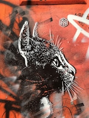 Wood-burned portrait of a cat showing dark shading and fine details.