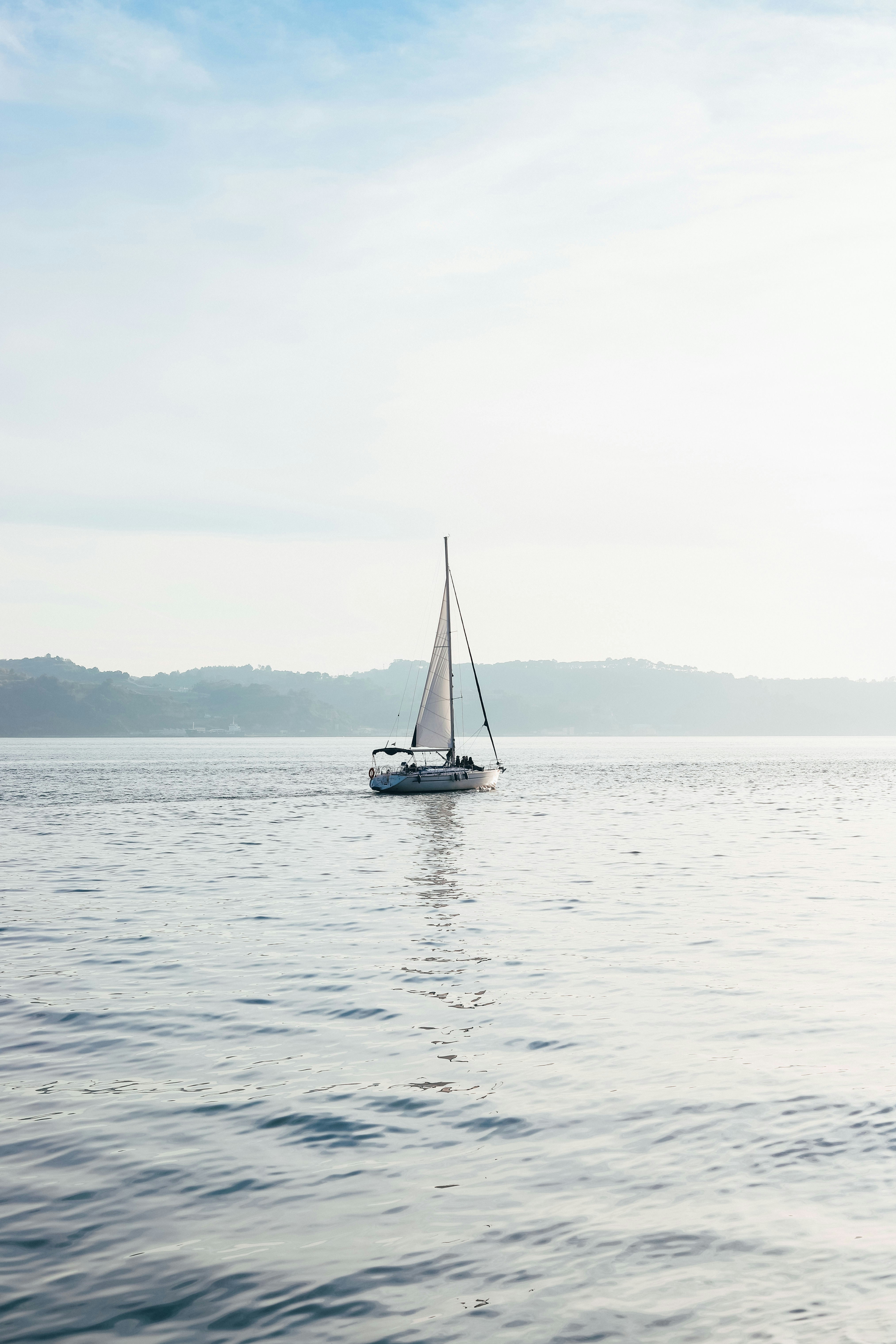white sailboat on body of water during daytime